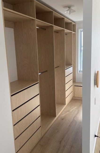Walk-in robe with timber finish and airgap drawers