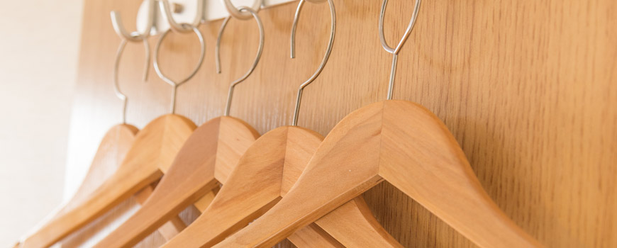 Wooden clothes hangers in a wardrobe